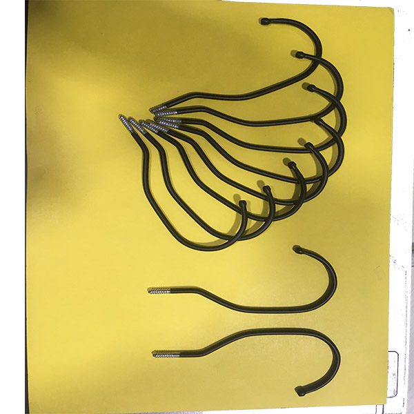 Metal components hanging on conveyor hooks for powder coating